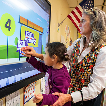 A teacher working with a student